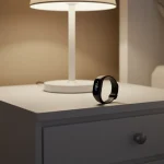 Fx Samsung Galaxy Fit3 displayed on modern nightstand with ambient bedroom lighting 3