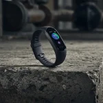 Fx Samsung Galaxy Fit3 fitness tracker artistically placed on concrete surface with industrial aesthetic 1