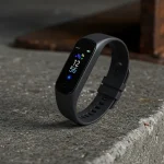 Fx Samsung Galaxy Fit3 fitness tracker artistically placed on concrete surface with industrial aesthetic 4