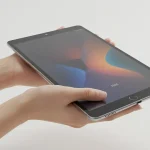 Fx Xiaomi Redmi Pad SE 11 tablet held in hands showing size comparison realistic human hands neutral background natural lighting 3