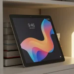 Fx Xiaomi Redmi Pad SE 11 tablet leaning against a stack of books on a contemporary bookshelf warm ambient lighting lifestyle photography 2
