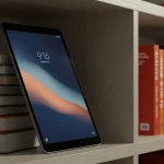Fx Xiaomi Redmi Pad SE 11 tablet leaning against a stack of books on a contemporary bookshelf warm ambient lighting lifestyle photography 4
