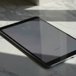 Fx Xiaomi Redmi Pad SE 11 tablet on a clean marble surface with geometric shadows high contrast artistic photography style 4