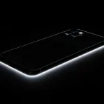 Fx Dramatic low angle shot of iPhone 16e against dark background rim lighting creating elegant silhouette professional commercial photography style 3