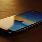 Fx Samsung budget smartphone resting on a leather surface with warm golden hour lighting 3