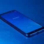 Fx Samsung budget smartphone resting on a metal surface with cool blue lighting 2