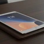 Fx Xiaomi Mi Pad placed on a leather portfolio case in a business setting with soft ambient lighting and professional atmosphere 2