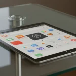 Fx Xiaomi Mi Pad tablet displaying a productivity app interface while positioned on a contemporary glass desk with natural daylight 1