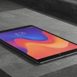 Fx Xiaomi Mi Pad tablet displaying vibrant content while placed on a contemporary concrete surface with industrial aesthetic 3