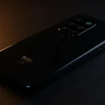 Fx Xiaomi Redmi Note 13 Pro Plus 5G in black color placed on dark wooden surface with ambient lighting creating premium atmosphere 4