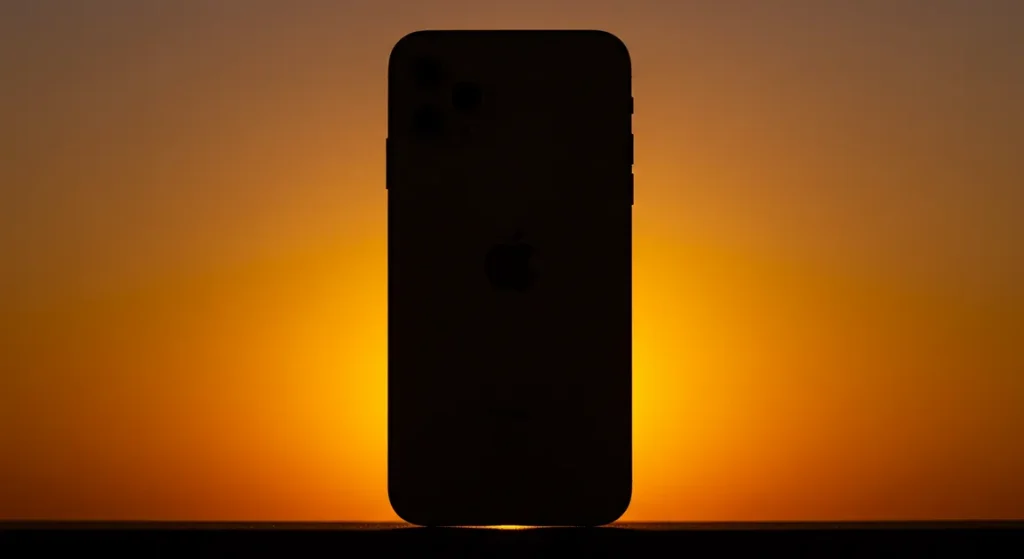 Fx iPhone 16e with dramatic backlighting creating halo effect silhouette style with subtle details visible artistic product photography approach 4